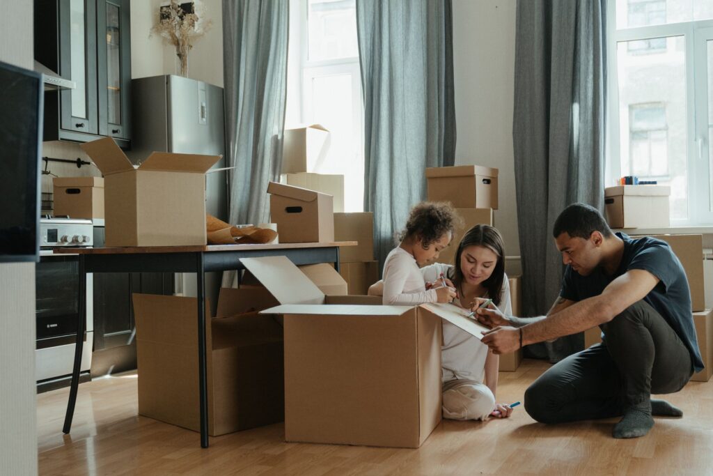 Family unpacking boxes after moving into a new home