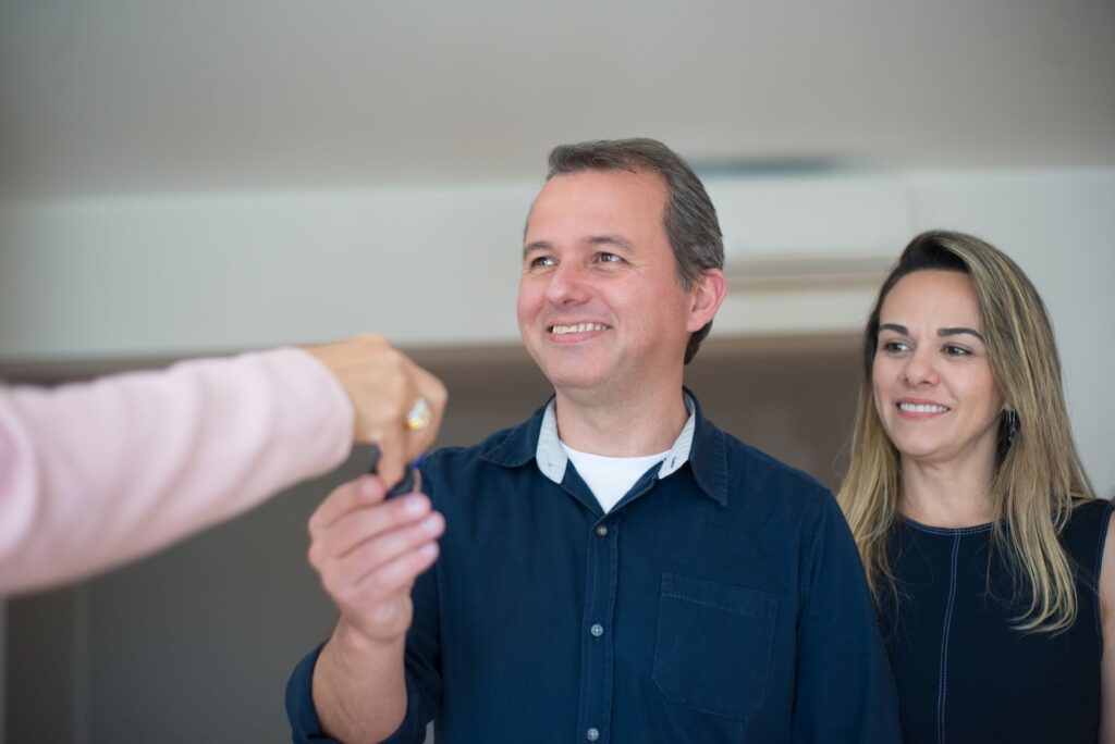 Couple receiving the keys to a new home